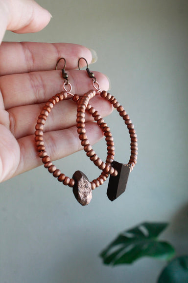 large hoop copper earrings with a quartz point