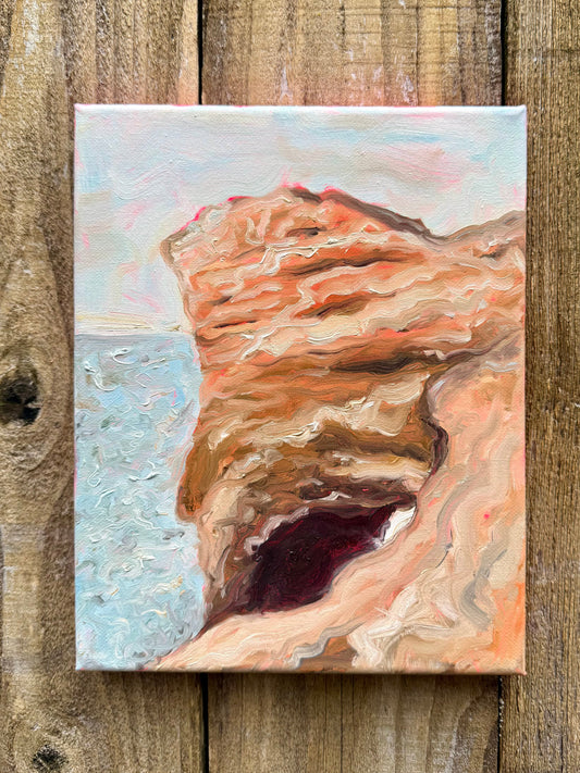 Painting of a natural landscape, an arch on a beach painted on a wooden surface