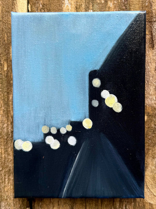 Abstract painting with blue and black background and white dots on a canvas