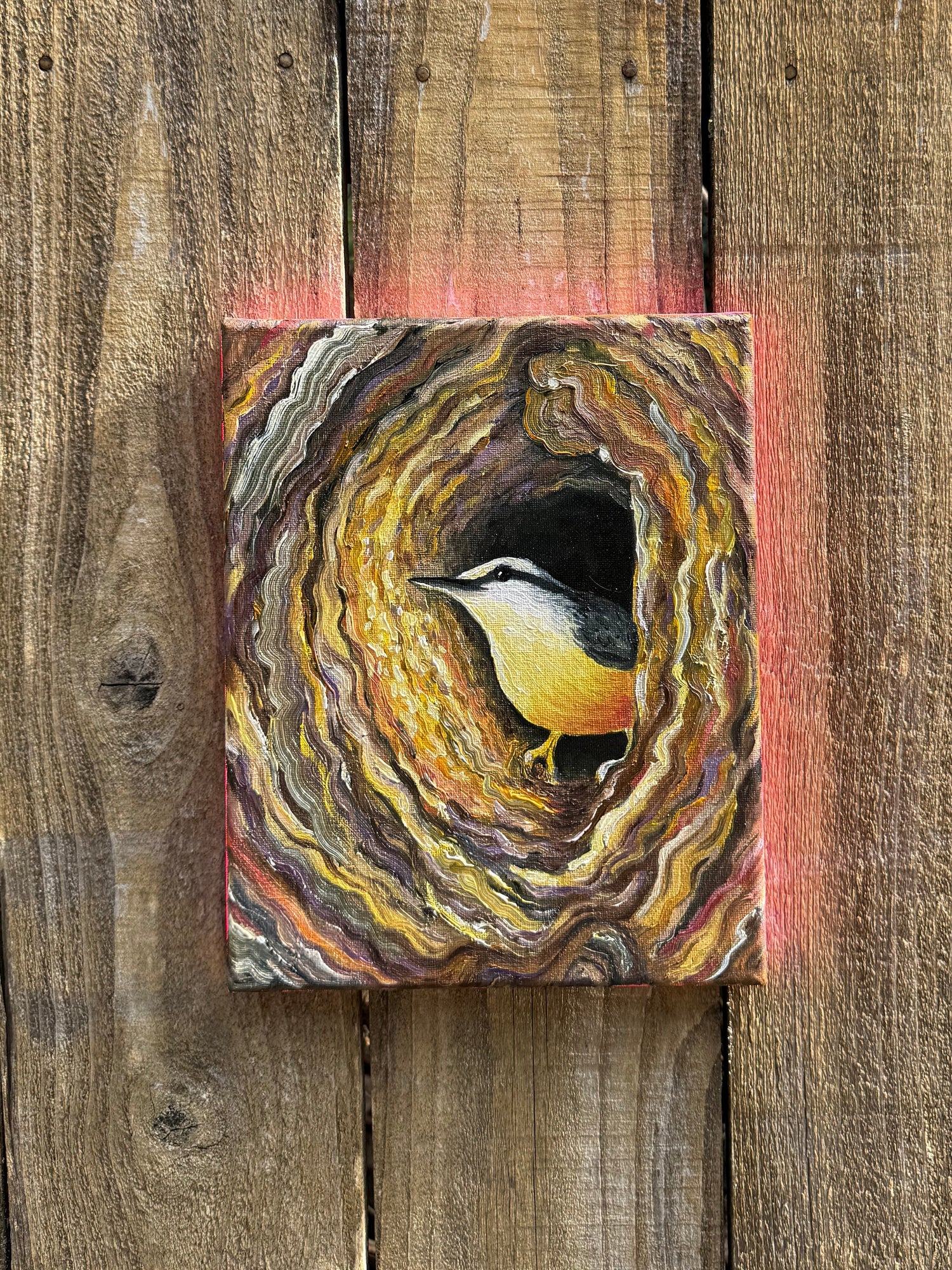 oil painting of a woodpecker burrowing inside a tree